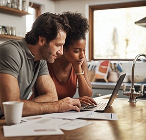a couple researching financing options for cosmetic dentistry