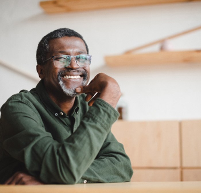 a smiling man sitting down