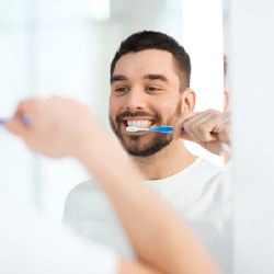 man brushing his teeth