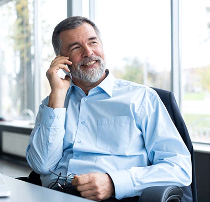 Man with dental implants in Houston making a phone call