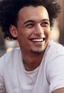 a man smiling after undergoing cosmetic dentistry