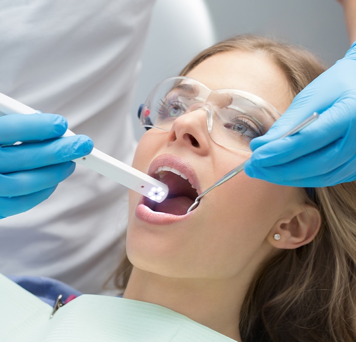 Woman receiving oral cancer screening