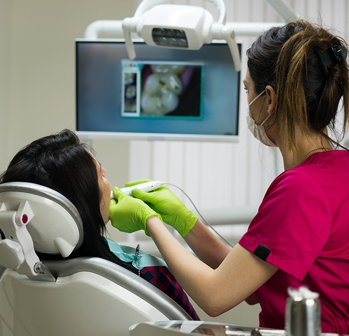 Dental team member using intraoral camera to capture smile images