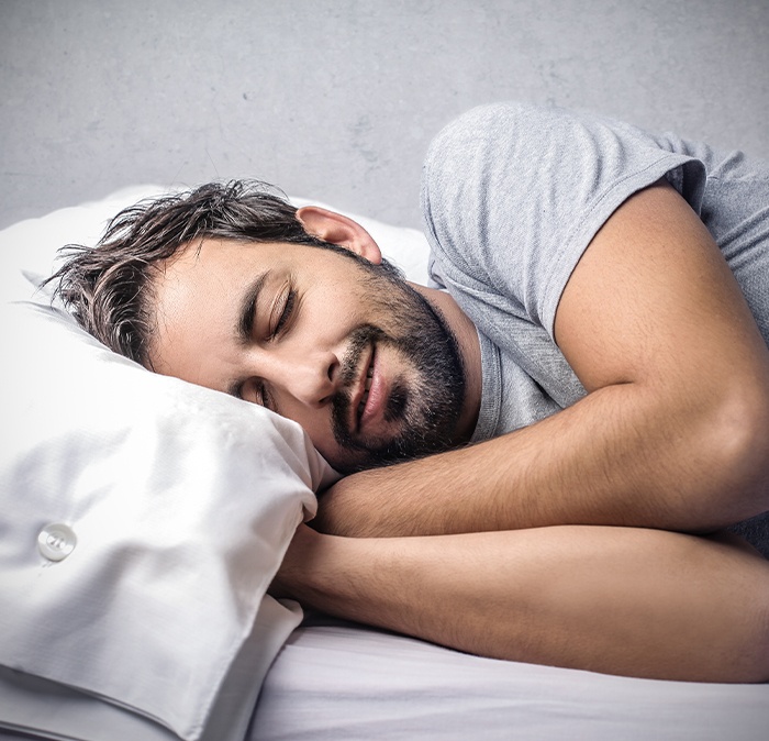 Man sleeping soundly thanks to sleep apnea therapy