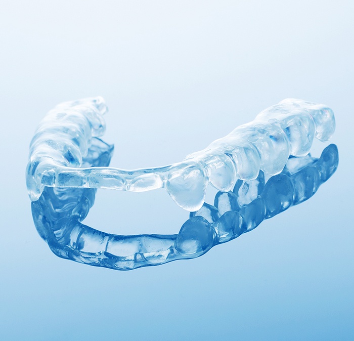 Clear occlusal splint on a blue background